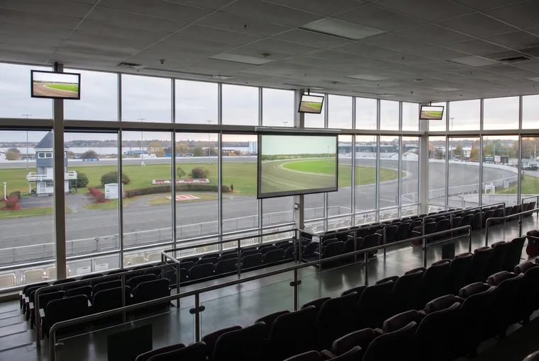 Indoor grandstand seats facing the oval and screens